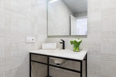 a bathroom with a sink and a mirror at Moontels Plaza de Vannes in Valencia