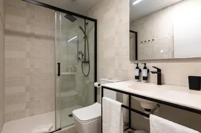 a bathroom with a shower and a sink and a toilet at Moontels Plaza de Vannes in Valencia
