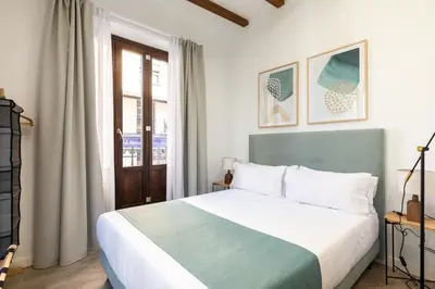 a bedroom with a large bed and a window at Moontels Plaza de Vannes in Valencia