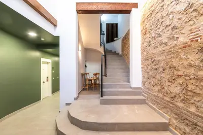 a hallway with a brick wall and stairs at Moontels Plaza de Vannes in Valencia