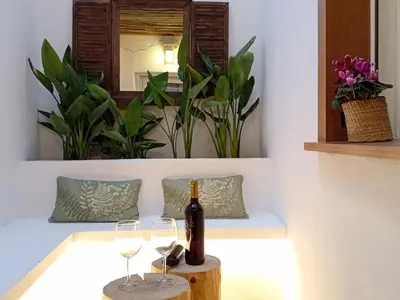 a bottle of wine sitting on a table with two glasses at El rinconet in Partida de La Cañada