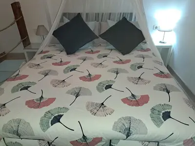 a bed with a comforter with umbrellas on it at APARTAMENTO MARÍTIMO in Valencia