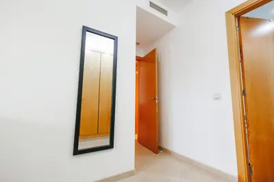 a mirror on a wall in a hallway at Lujoso apartamento de dos habitaciones en la playa de Canet in Canet de Berenguer