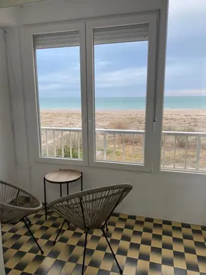 a hallway of a building with a checkered floor at Primera línea de playa in Valencia