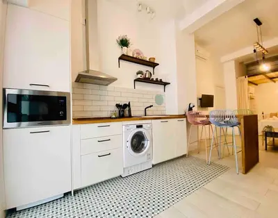 a kitchen with a washer and a washing machine at Beautiful LOFT in the HEART of Ruzafa, SOHO in Valencia