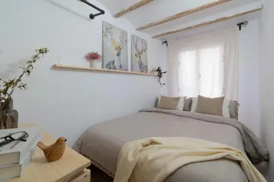 a living room with a table and a couch at Calderona Tiny house in Segorbe