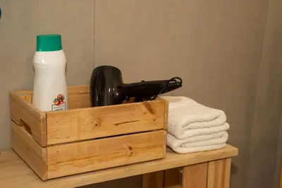 a wooden box with a hair dryer and a bottle of milk at lifecoliving valencia loft A in Valencia