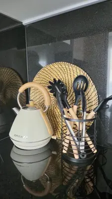 a basket of kitchen utensils sitting on a table at Imperial Apartamentos Valencia in Valencia