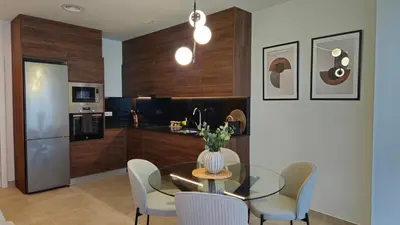 a dining room with a table and chairs and a kitchen at Imperial Apartamentos Valencia in Valencia