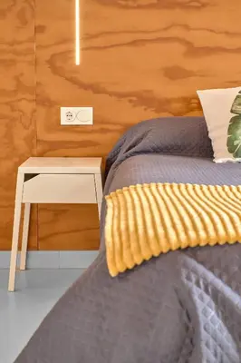 a bedroom with a bed with a table next to it at Apartamento soleado en plaza del Carmen in Valencia