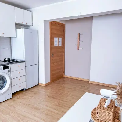 a kitchen with a washer and dryer next to a door at Studio Aiora in Valencia