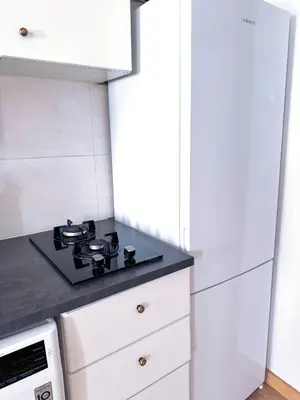 a kitchen with white cabinets and a stove top oven at Studio Aiora in Valencia