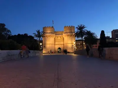 a large building with a castle at night at Loft con estilo y terraza en centro histórico in Valencia
