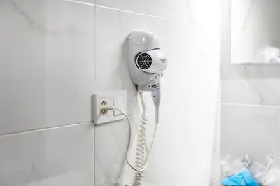 a blow dryer on a wall in a bathroom at Precioso Loft Sorolla en Playa Malvarrosa/Patacona in Valencia