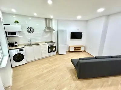 a living room with a couch and a kitchen at Patraix nice suite in Valencia