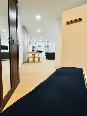a room with a bed and a dining room at Patraix nice suite in Valencia