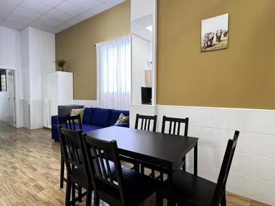 a dining room with a table and a blue couch at Cooperativa 8 in Valencia
