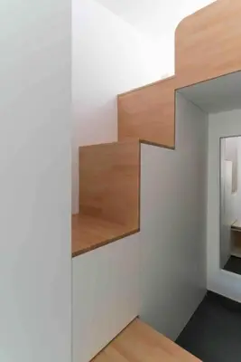 a staircase in a room with white walls and wood at Calma Villa. Chalet de lujo, jacuzzi y piscina in Valencia