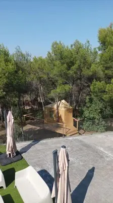 a playground with umbrellas in front of a building at Calma Villa. Chalet de lujo, jacuzzi y piscina in Valencia