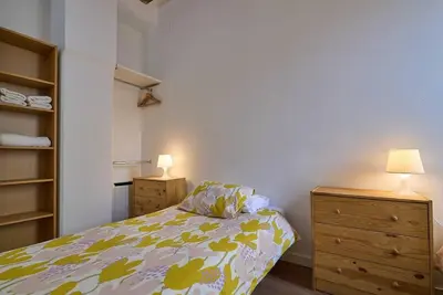 a bedroom with a bed and a dresser and lamp at Apartamento minimalista en Matemático Marzal in Valencia