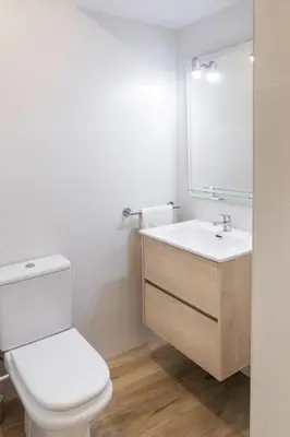 a bathroom with a white toilet and a sink at Furio Silence in Valencia