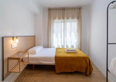 a small bedroom with a bed and a window at Furio Silence in Valencia
