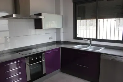 a kitchen with purple cabinets and a sink at Sierra de Chiva Villa in Chiva