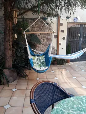 a blue hammock hanging on a patio at La Casa Del Teix in Eslida