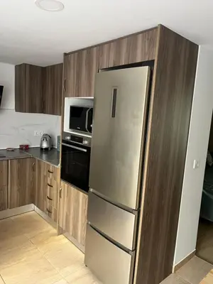 a kitchen with a stainless steel refrigerator and a microwave at Cullera Mountain View in Cullera