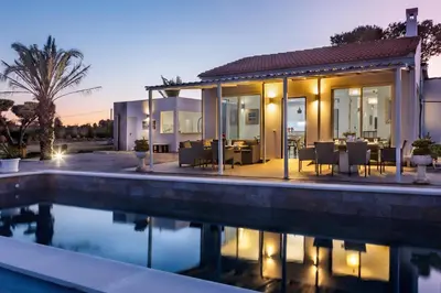 a villa with a swimming pool at dusk at La Villa de Luz in Torrent