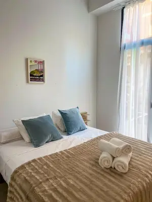 a bedroom with a large bed with towels on it at Non Stress Templo in Valencia