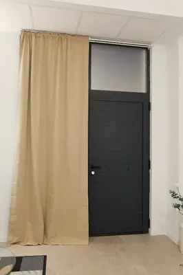 a black door with a curtain in a room at Non Stress Templo in Valencia