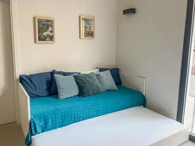 a room with a blue couch with pillows on it at Non Stress Templo in Valencia
