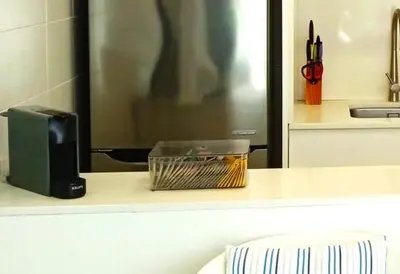 a kitchen counter with a microwave and a basket of food at Apartamento frente al mar in Cullera