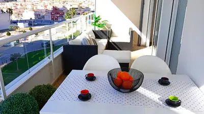a table with a bowl of fruit on a balcony at Apartamento frente al mar in Cullera