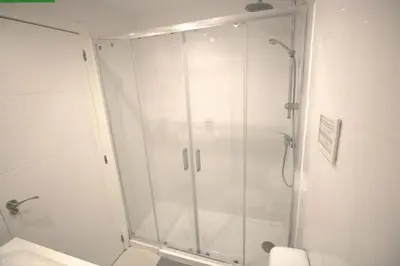 a bathroom with a shower with a glass door at Tus Habitaciones en Ruzafa in Valencia