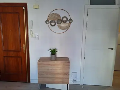 a room with a table with a potted plant on the wall at Cullera Playa in Cullera