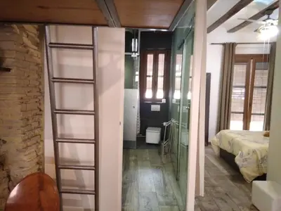 a room with a bed and a room with a ladder at Valencia Centro Suite in Valencia