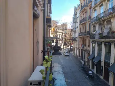 an empty street in a city with buildings at Valencia Centro Suite in Valencia