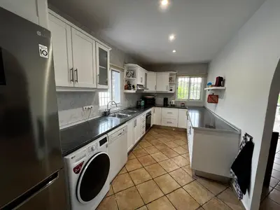 a kitchen with white cabinets and a sink and a dishwasher at Casa el Girasol, rustig gelegen kindvriendelijke villa 10 p in Montroy