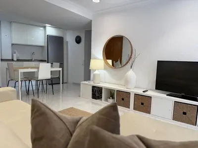 a living room with a flat screen tv and a table at Encanto exclusivo en pleno centro de Valencia in Valencia