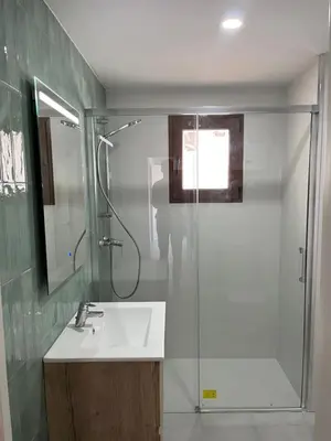a bathroom with a sink and a glass shower at Cap Blanc Apartment with Sea View and Beach in Cullera