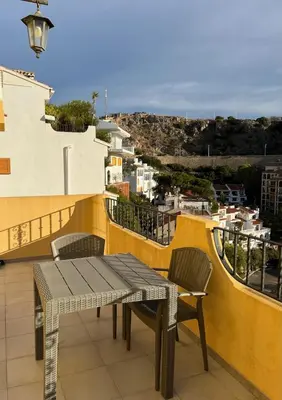 a table and chairs on a balcony with a view at Cap Blanc Apartment with Sea View and Beach in Cullera