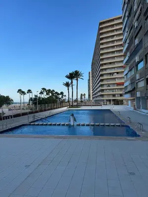 a swimming pool in the middle of a building at Apto. Cullera vistas espectaculares primera línea in Cullera