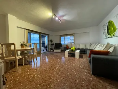 a living room with a couch and a table at Apto. Cullera vistas espectaculares primera línea in Cullera