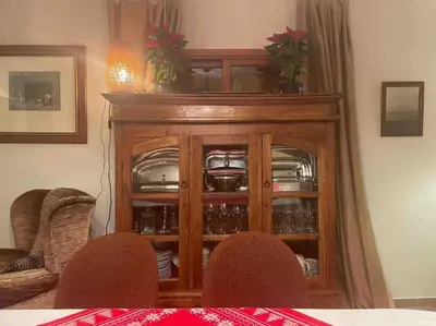 a wooden cabinet with dishes inside of it at Agradable Casa con maravillosas vistas in Chiva