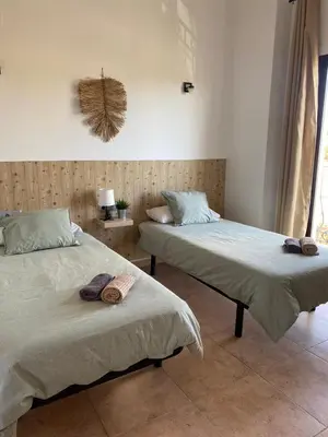 two beds sitting next to each other in a room at Hostal Espai Mediterrani in Puebla de Vallbona