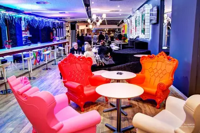 a restaurant with red and orange chairs and tables at Urban Youth Hostel in Valencia