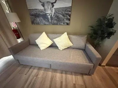a couch with two pillows in a living room at Loft para 6 pax, 15 min de Ciencias y Artes y AC in Valencia