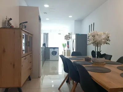 a kitchen and dining room with a table and chairs at MalvaLindaBeach Preciosa Casa Malvarrosa-Patacona in Valencia